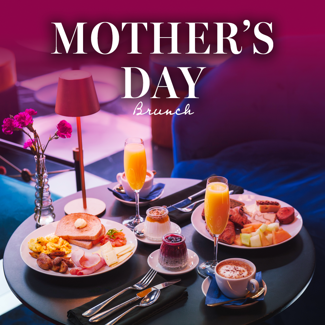 Mother’s Day brunch at Bijou restaurant featuring an elegant table with gourmet breakfast plates, croissants, fruit, coffee and mimosas in a stylish, colorful setting